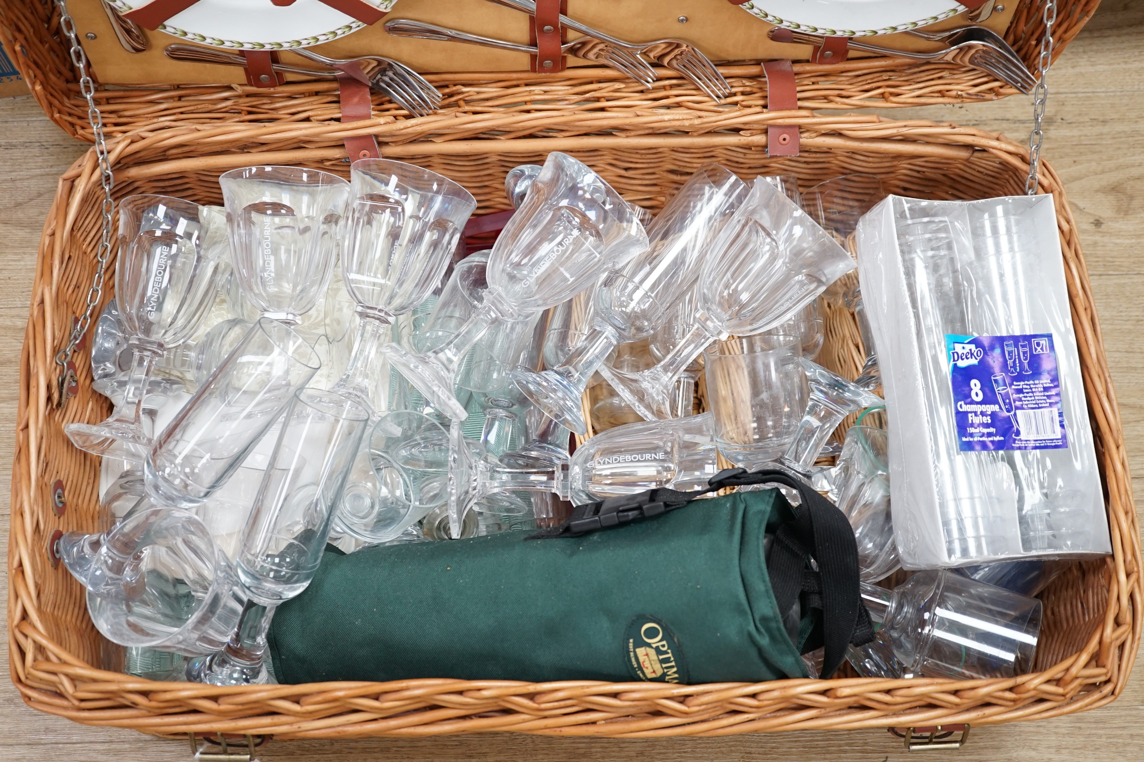 A wicker picnic hamper with assorted Glyndebourne plastic goblets, hamper 72cms wide x 39cms deep